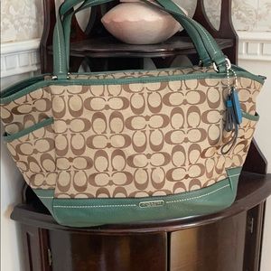Coach bag satchel style with green leather accents